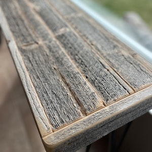 Reclaimed barnwood console table. Made with reclaimed cedar barnwood from Manitoulin Island. Black powder-coated steel hairpin legs.