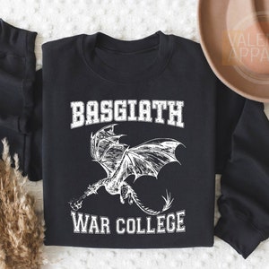 May include: Black sweatshirt with a white graphic of a dragon and the text "Basgiath War College".