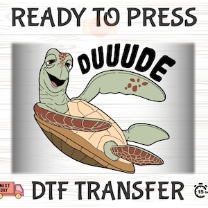 May include: A green sea turtle with a brown shell and the word "DUUUDE" in black text. The image is for a DTF transfer.