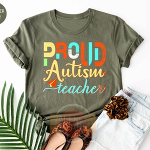a t - shirt that says proud autism teacher