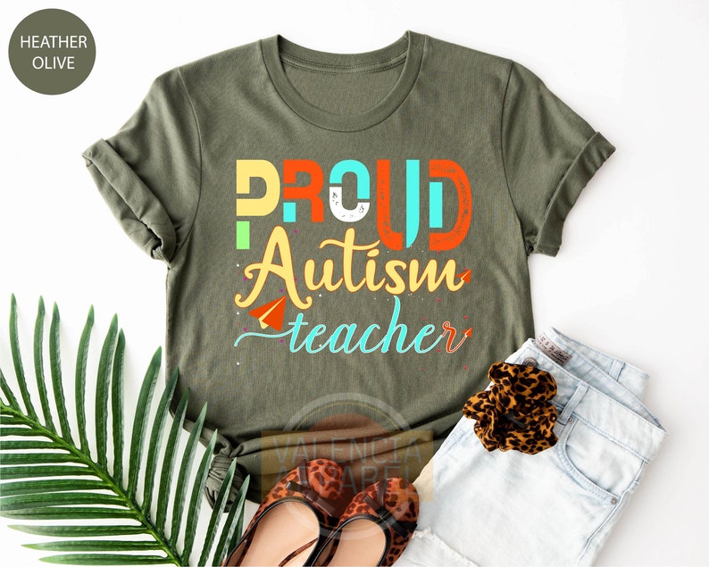 a t - shirt that says proud autism teacher