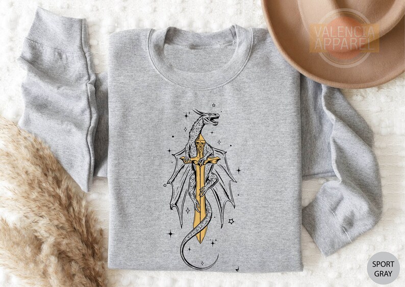 a gray shirt with a yellow dragon on it