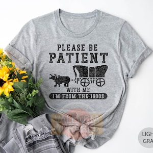 a t - shirt that says please be patient with me i'm from the