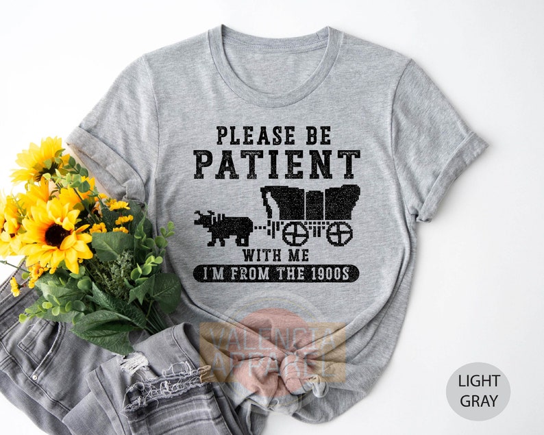 a t - shirt that says please be patient with me i'm from the