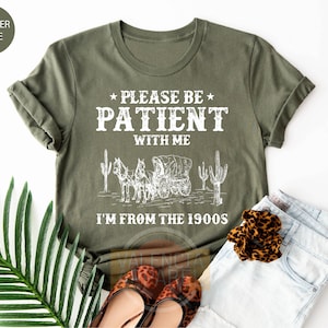 a t - shirt that says please be patient with me i'm from the