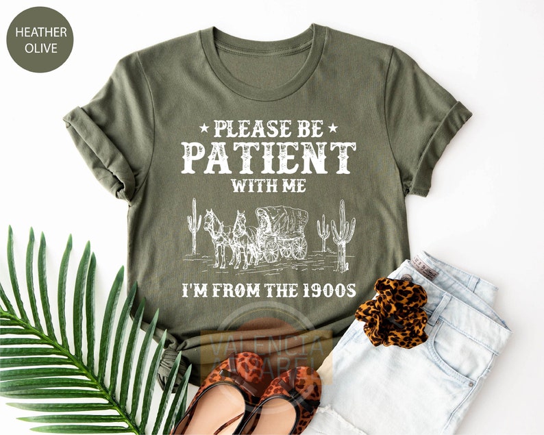 a t - shirt that says please be patient with me i'm from the