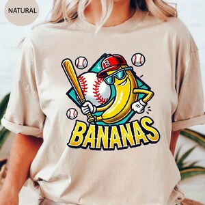 a woman wearing a t - shirt with a baseball bat and banana on it