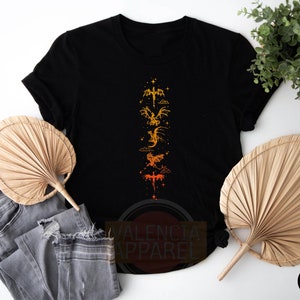 a black t - shirt with a picture of a dragon on it