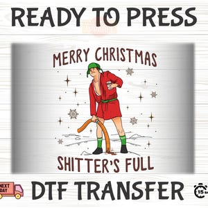 May include: A DTF transfer design with the text "READY TO PRESS" and "MERRY CHRISTMAS". The graphic features a cartoon character in a red robe and green hat, holding a hose. The text "SHITTER'S FULL" is also included.