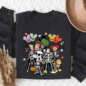 a black shirt with mickey mouse and friends on it
