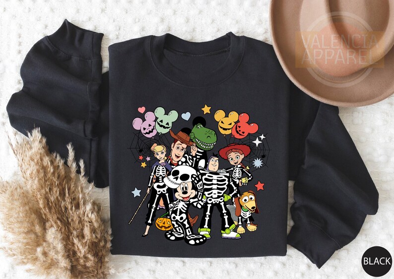 a black shirt with mickey mouse and friends on it