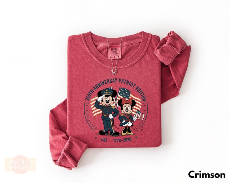 A red long-sleeved t-shirt with a graphic design featuring Minnie Mouse and Mickey Mouse in military uniforms, along with a patriotic theme.