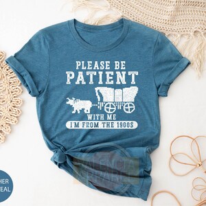 a t - shirt that says please be patient with me i'm from the