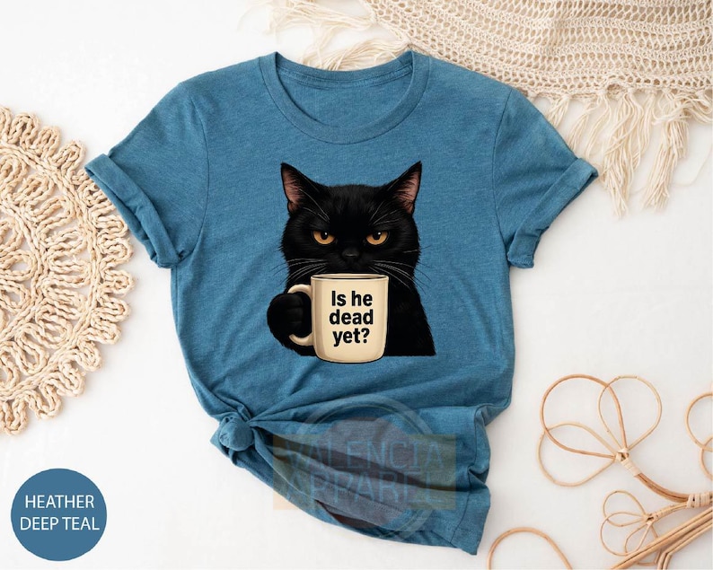 a t - shirt with a black cat holding a cup of coffee