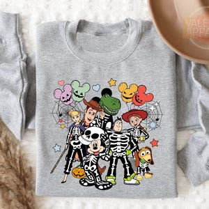 a couple of cartoon characters on a gray shirt