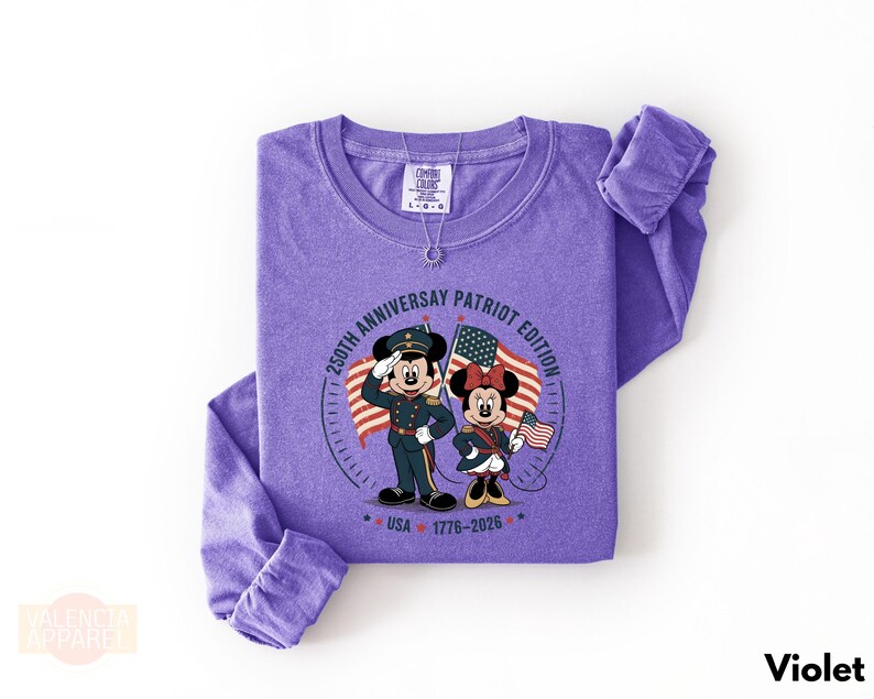 A purple long-sleeved t-shirt with a graphic design featuring Minnie Mouse and Mickey Mouse, along with text and a date.