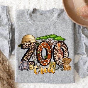 a gray shirt with a picture of zoo animals on it