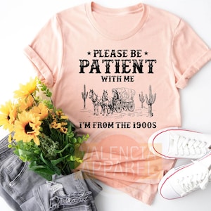 a t - shirt that says please be patient with me i'm from the