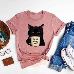 a t - shirt with a black cat holding a cup of coffee