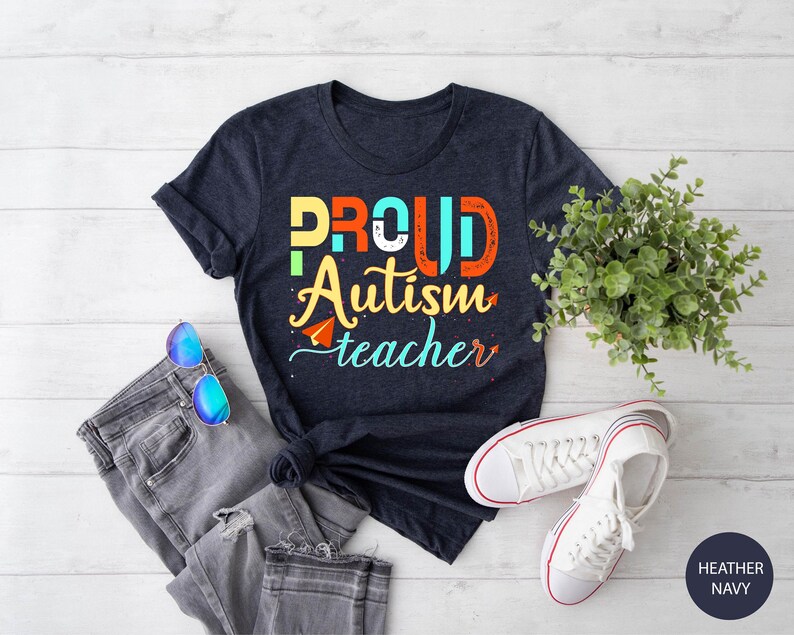a t - shirt that says proud autism teacher