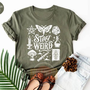 a t - shirt that says stay weird on it