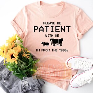 a t - shirt that says please be patient with me i'm from the