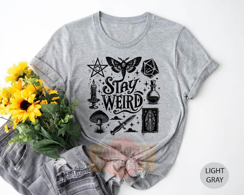 a t - shirt with the words stay weird on it