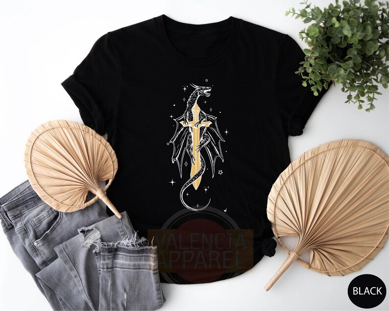 a t - shirt with a cross and a dragon on it