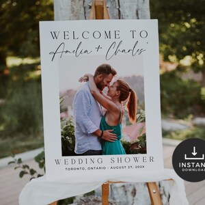 May include: A white wedding sign on an easel with the text "WELCOME TO Amelia + Charles" above a photo of a couple embracing. Below the photo, it reads "WEDDING SHOWER, TORONTO, ONTARIO, AUGUST 27, 202X." A black circle with "INSTANT DOWNLOAD" is in the bottom right.