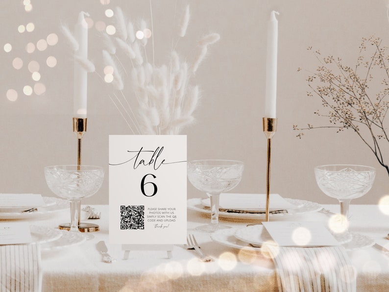 May include: White table number card with black calligraphy that reads "table 6". A black and white QR code is below the number with the text "Please share your photos with us. Simply scan the QR code and upload. Thank you!"