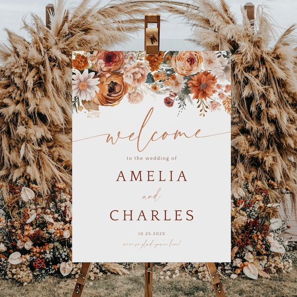 Może przedstawiać: Witamy znak weselny z aranżacjami kwiatowymi w odcieniach pomarańczu, kremu i bordo. Znak głosi "welcome" i imiona "AMELIA i CHARLES" z datą "10.25.2023". Znak znajduje się na sztaludze.