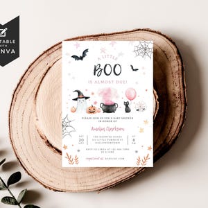 May include: A rectangular baby shower invitation card featuring Halloween-themed watercolor illustrations including a ghost in a witch hat, a black cauldron with pink smoke, a black cat with a pink balloon, pumpkins, bats, and spiderwebs.