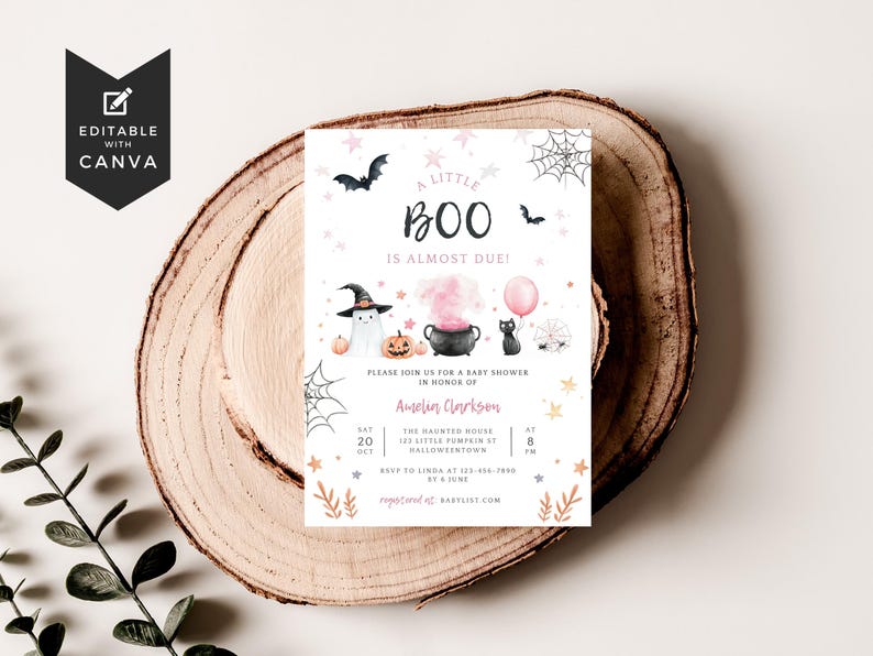 May include: A rectangular baby shower invitation card featuring Halloween-themed watercolor illustrations including a ghost in a witch hat, a black cauldron with pink smoke, a black cat with a pink balloon, pumpkins, bats, and spiderwebs.