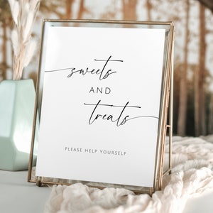 May include: A white sign with black calligraphy that reads "sweets and treats" and "please help yourself" in a gold frame.