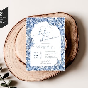May include: Blue and white floral baby shower invitation with the text "Please join us for a baby shower in honor of Michelle Giuleur. Sat 25 May. The Conrad Home 123 Center Street West Your City. RSVP to Amanda at 123-456-7890 by Nov 18. Registered at Target and Amazon."