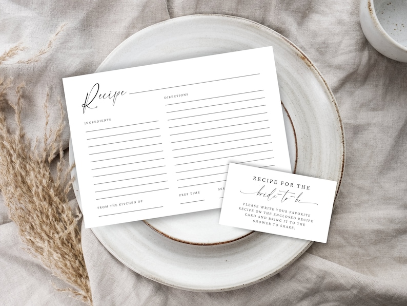 May include: A white recipe card with the text "Recipe" at the top, followed by "Ingredients" and "Directions". There is a smaller white card with the text "Recipe for the bride-to-be" and instructions to write a favorite recipe on the enclosed card and bring it to the shower to share.