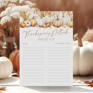 May include: Thanksgiving potluck sign-up sheet with a watercolor illustration of pumpkins and wheat. The sign-up sheet has lines for names and contributions. The background features pumpkins, dried flowers, and pampas grass.