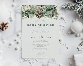 May include: A baby shower invitation with a winter theme. The invitation has a floral and pinecone border. The text reads "Baby Shower" and includes the honoree's name, date, and location. The invitation is on a white background.