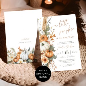 May include: Two rectangular baby shower invitation cards featuring watercolor illustrations of orange and white pumpkins, dried wheat, and autumn leaves. The front card displays the text A little pumpkin is on the way, Amelia Clarkson, and event details. The back card is blank.