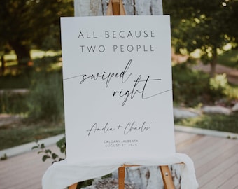 Puede incluir: Un letrero blanco sobre un caballete de madera con el texto "ALL BECAUSE TWO PEOPLE swiped right". Debajo, los nombres "Amelia + Charles" y la fecha y el lugar del evento.