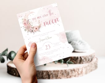 May include: Pink and white baby shower invitation with a crescent moon and floral design. The text reads "We are over the moon" and includes the name "Jessica Oliver" and the date "March 23".