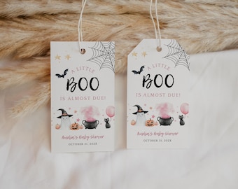 May include: Two rectangular white gift tags with string loops featuring black spiderwebs, a bat, and the text A LITTLE BOO IS ALMOST DUE. Below are illustrations of a ghost in a witch hat, a pumpkin, a cauldron with pink smoke, and a black cat with a balloon.
