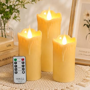 May include: Three cream-colored LED pillar candles with realistic melted wax edges and glowing flame-shaped tips. The set includes a rectangular remote control with buttons for timer settings, light modes, and brightness adjustment, all in a soft warm glow.