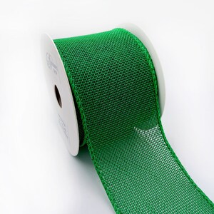 May include: A roll of green burlap ribbon with a wired edge. The ribbon is on a white spool.