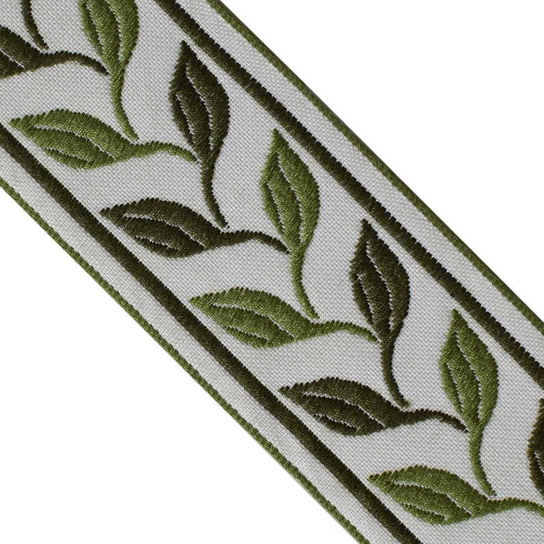May include: Decorative ribbon featuring embroidered green leaves on a light gray background. The leaves are detailed with varying shades of green, and the ribbon is bordered by dark green stripes. This trim is suitable for various craft and sewing projects.