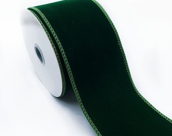 May include: A roll of dark green velvet ribbon with a green satin edge.