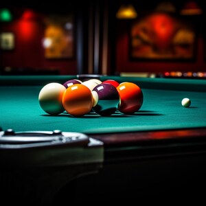 May include: A green felt pool table with a rack of billiard balls, including a white cue ball, a solid red ball, a solid orange ball, a solid yellow ball, a solid black ball, and a solid red ball. The balls are arranged in a triangle formation on the table.