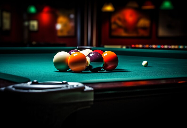May include: A green felt pool table with a rack of billiard balls, including a white cue ball, a solid red ball, a solid orange ball, a solid yellow ball, a solid black ball, and a solid red ball. The balls are arranged in a triangle formation on the table.