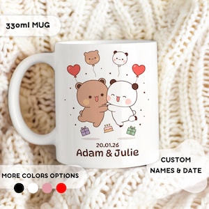 May include: A white 330ml mug featuring a graphic of a brown bear and a white panda bear holding hands, surrounded by heart-shaped balloons, small gifts, and a cake. The text reads 20.01.26 and Adam & Julie in brown lettering.