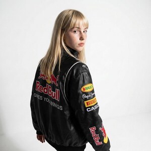 May include: Black leather jacket with Red Bull logos and patches. The jacket has white piping and the text "Gives You Wings" on the back. Patches include "RAUCH", "Pepe Jeans", "IRELLI", and "CASIO".